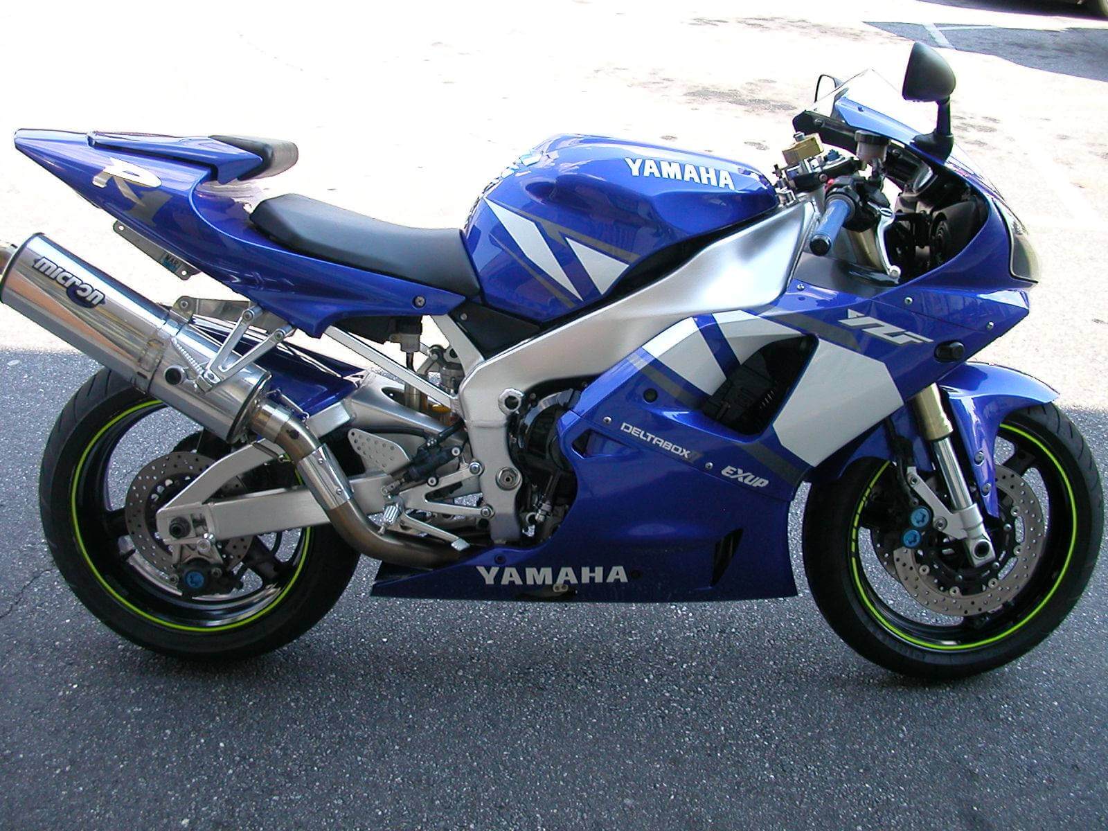A sleek blue Yamaha sport motorcycle parked outdoors.